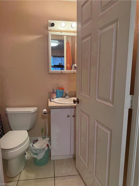 2531 47th Terrace Southwest Naples, FL 34116 - Photo 9 of 17 a bathroom with a toilet sink and mirror