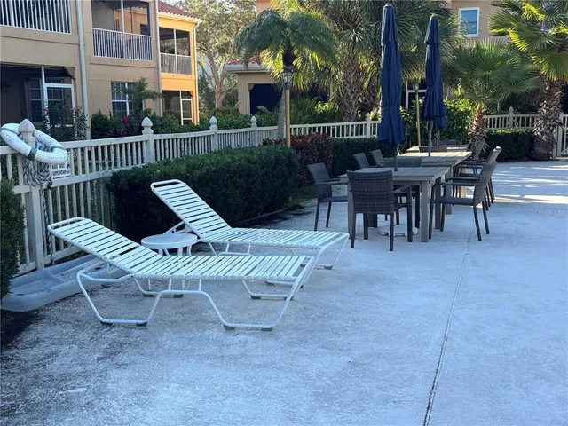 a view of a patio with a table and chairs