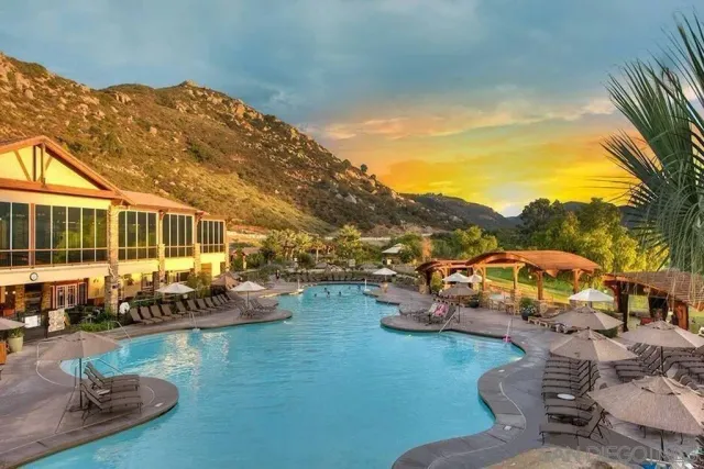 an aerial view of a house with swimming pool garden view and a lake view