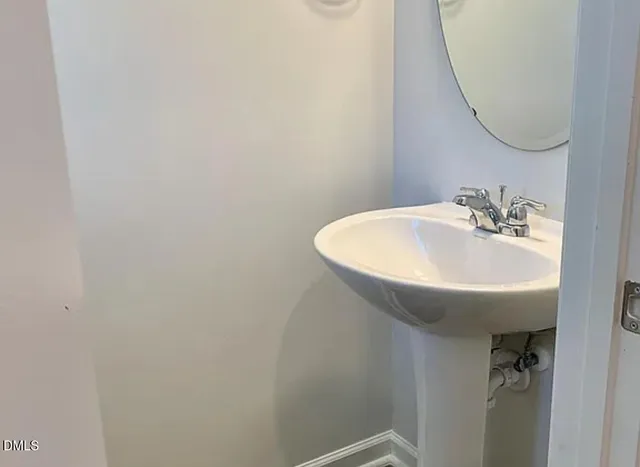 a view of a house with a large window and wooden fence