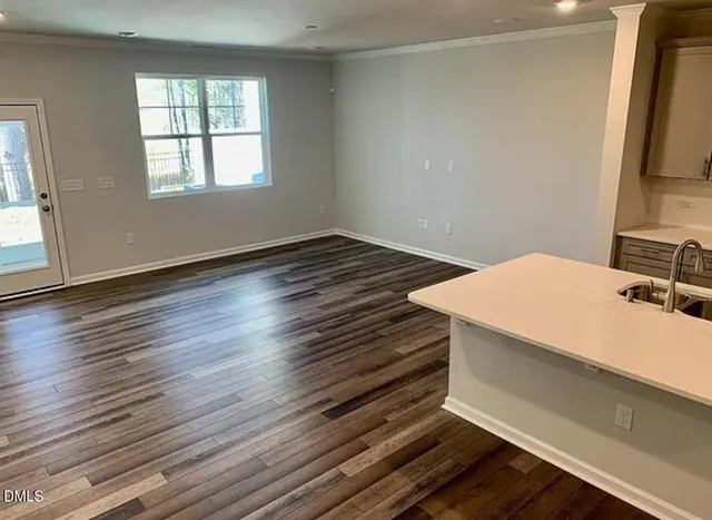 a room with a bed and a dresser