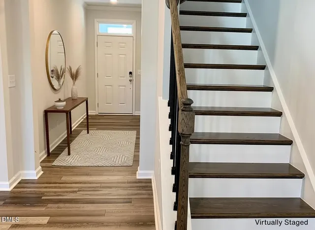 a view of entryway and hall with wooden floor