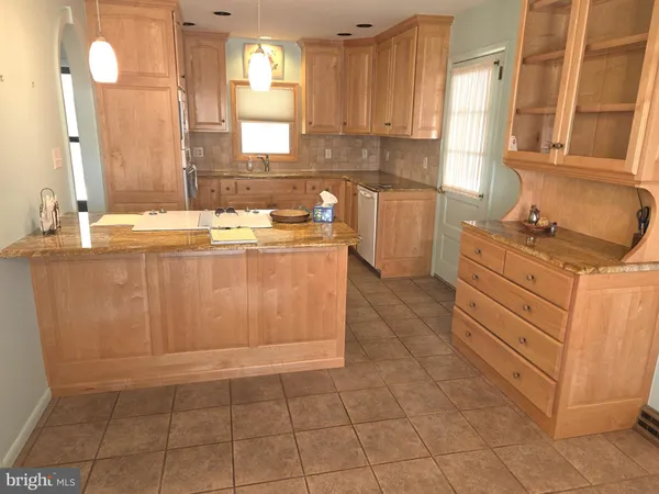 a kitchen with a stove a sink a refrigerator and cabinets
