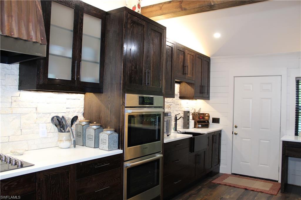 6285 Parkers Hammock Road, Unit B Naples, FL 34112 - Photo 11 of 33 a kitchen with a sink and stainless steel appliances