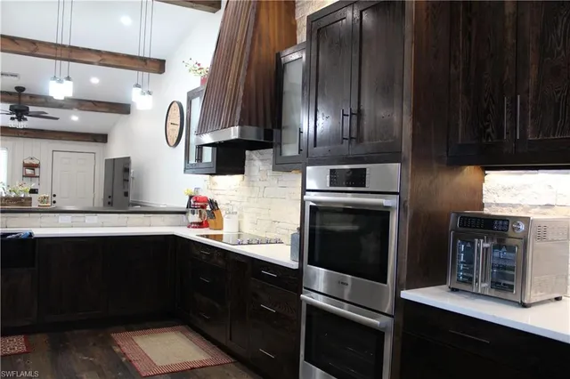 a kitchen with stainless steel appliances a sink stove and cabinets