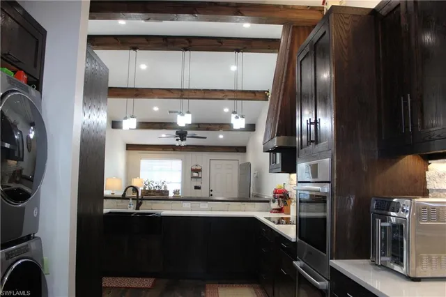 a kitchen with stainless steel appliances granite countertop a sink stove and refrigerator