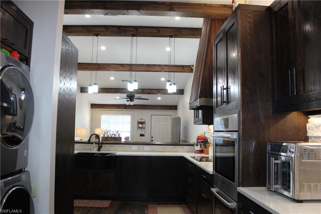 6285 Parkers Hammock Road, Unit B Naples, FL 34112 - Photo 15 of 33 a kitchen with stainless steel appliances granite countertop a sink stove and refrigerator