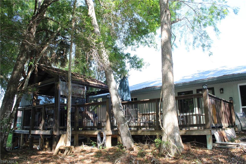 6285 Parkers Hammock Road, Unit B Naples, FL 34112 - Photo 29 of 33 a view of house with a tree in it