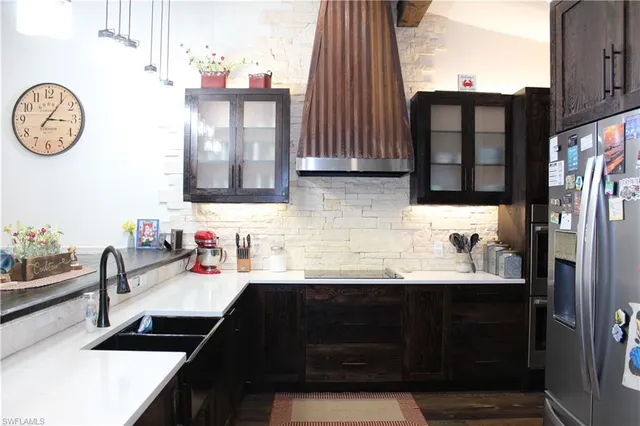 a kitchen with a sink and a stove top oven