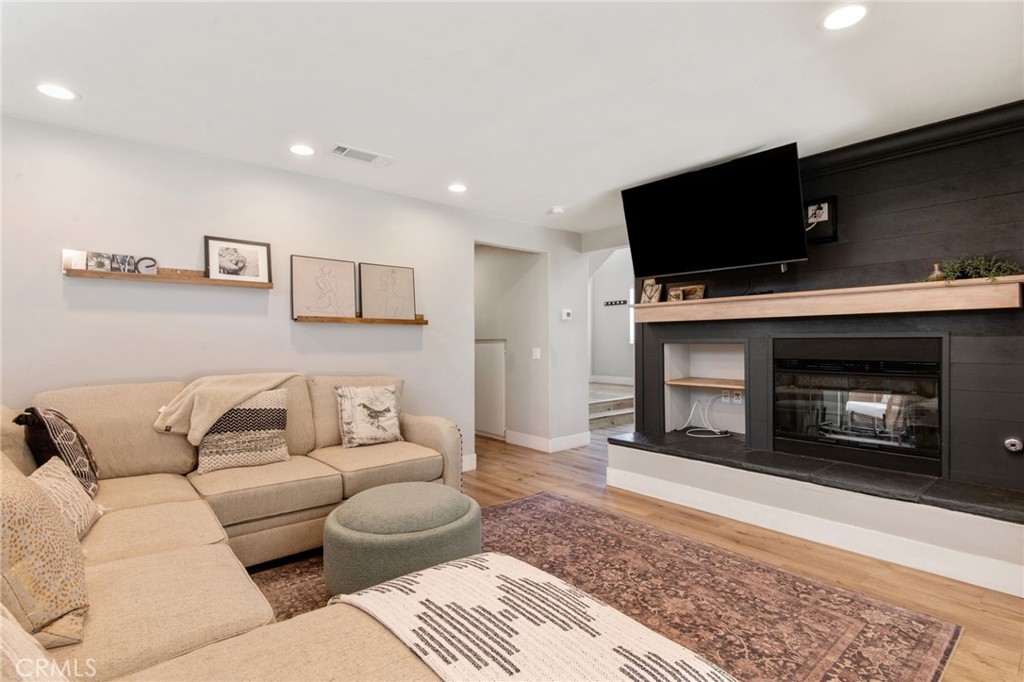 40456 Windsor Road Temecula, CA 92591 - Photo 10 of 38 a living room with furniture a flat screen tv and a fireplace