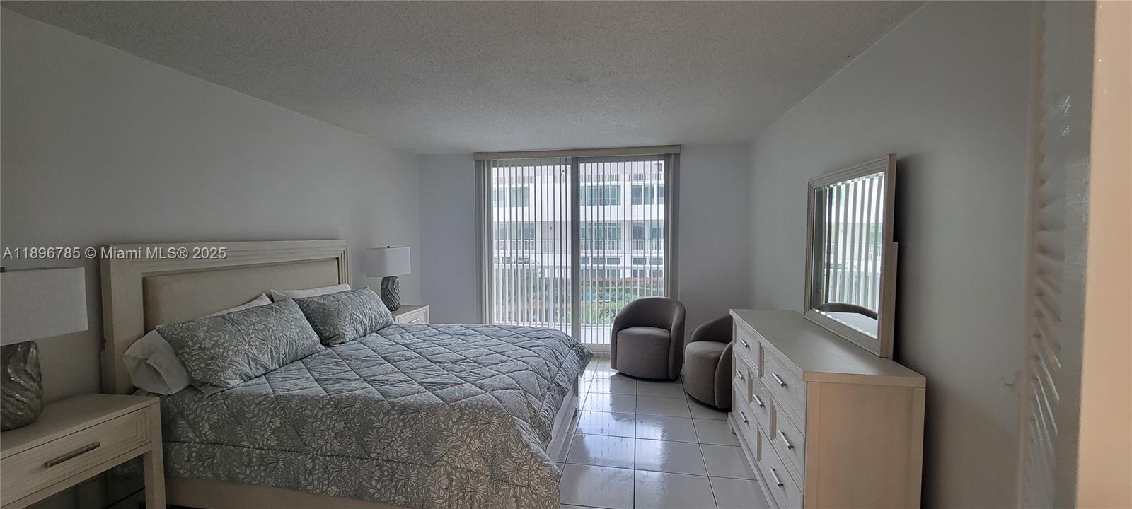 5401 Collins Avenue, Unit 214 Miami Beach, FL 33140 - Photo 11 of 37 a bedroom with a bed and a window