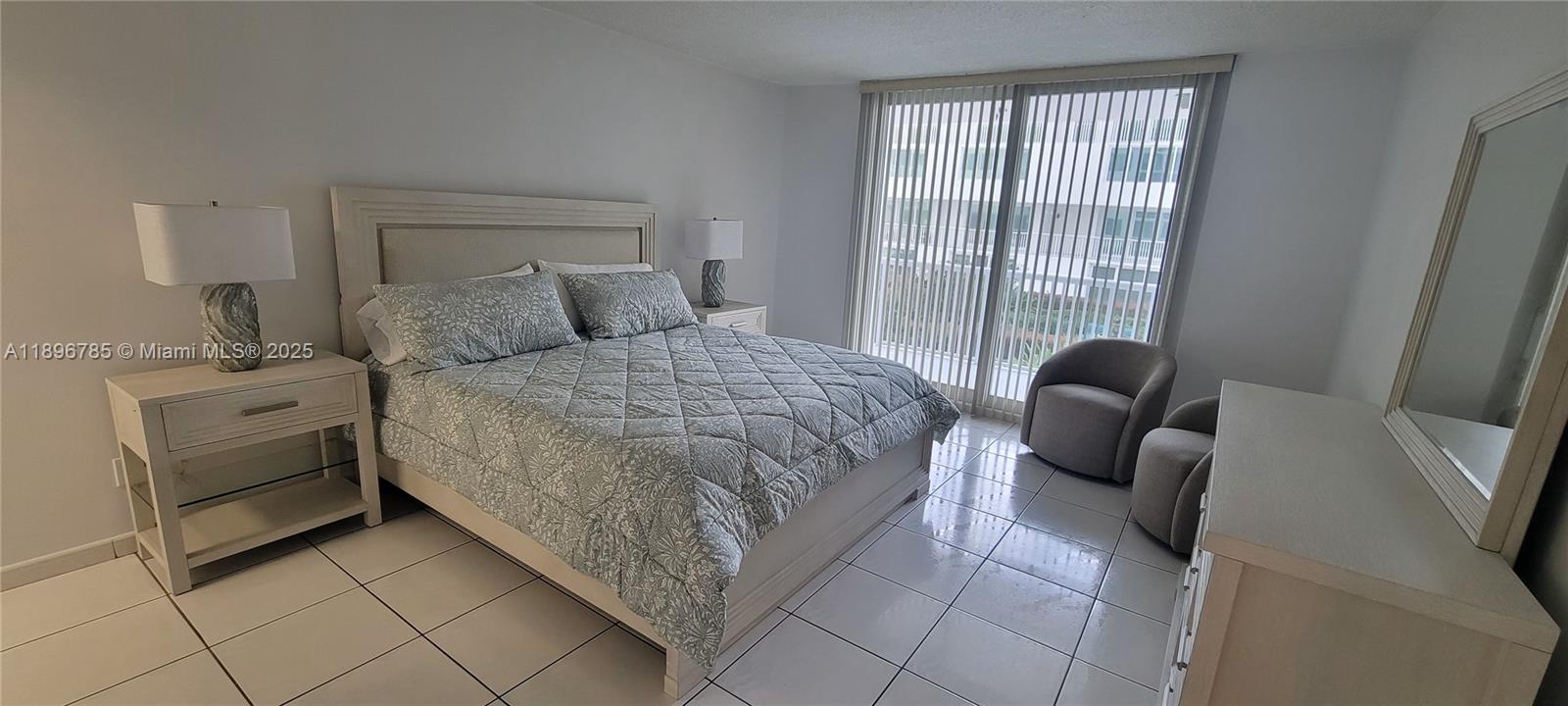 5401 Collins Avenue, Unit 214 Miami Beach, FL 33140 - Photo 12 of 37 a bedroom with a bed and a couch