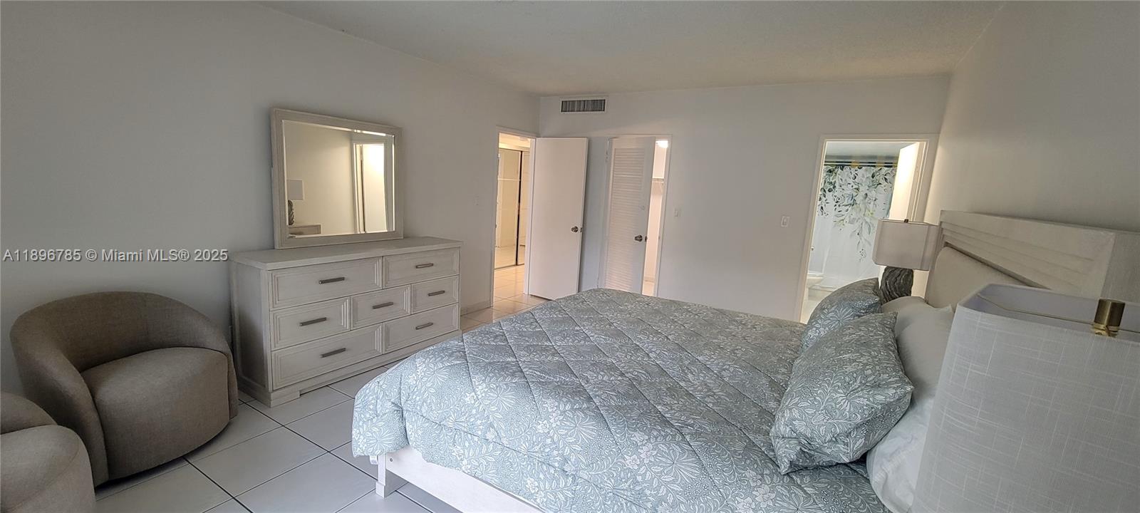 5401 Collins Avenue, Unit 214 Miami Beach, FL 33140 - Photo 13 of 37 a bedroom with a bed and a couch