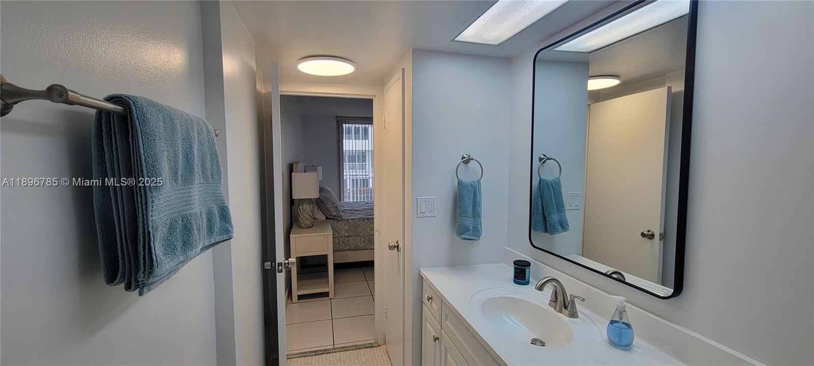 5401 Collins Avenue, Unit 214 Miami Beach, FL 33140 - Photo 16 of 37 a bathroom with a sink and mirror