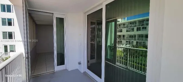 a view of a porch with chairs and potted plants