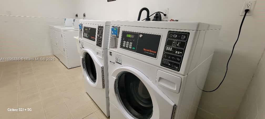 5401 Collins Avenue, Unit 214 Miami Beach, FL 33140 - Photo 24 of 37 a utility room with dryer and washer