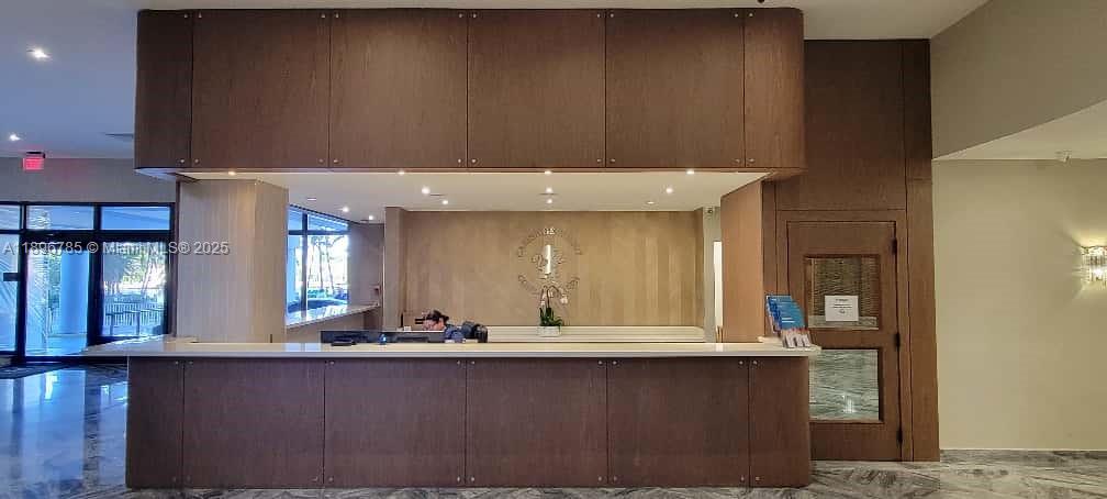 5401 Collins Avenue, Unit 214 Miami Beach, FL 33140 - Photo 4 of 37 a view of a kitchen with granite countertop stainless steel appliances a sink and a counter top space