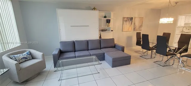 a kitchen with white cabinets and refrigerator