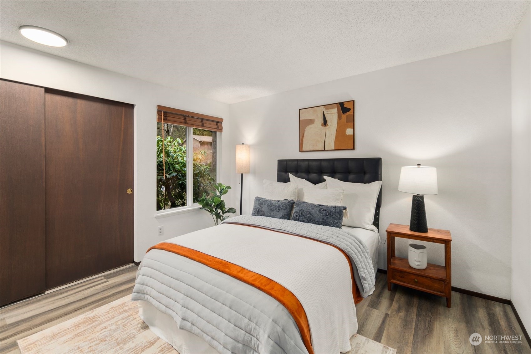 6104 145th Street Southwest Edmonds, WA 98026 - Photo 18 of 29 a bedroom with a bed and wooden floor