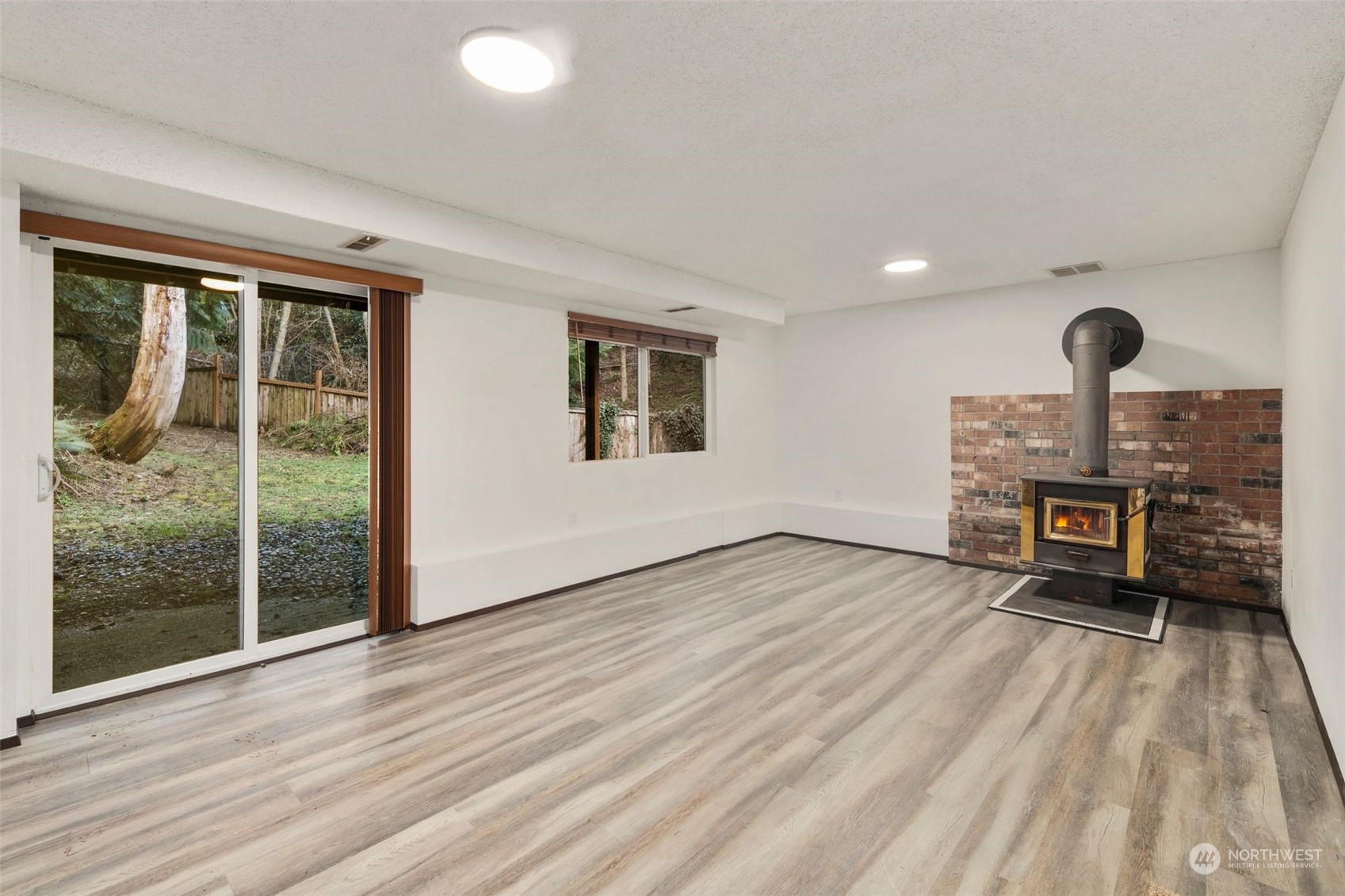 6104 145th Street Southwest Edmonds, WA 98026 - Photo 24 of 29 a view of empty room with wooden floor and floor to ceiling window