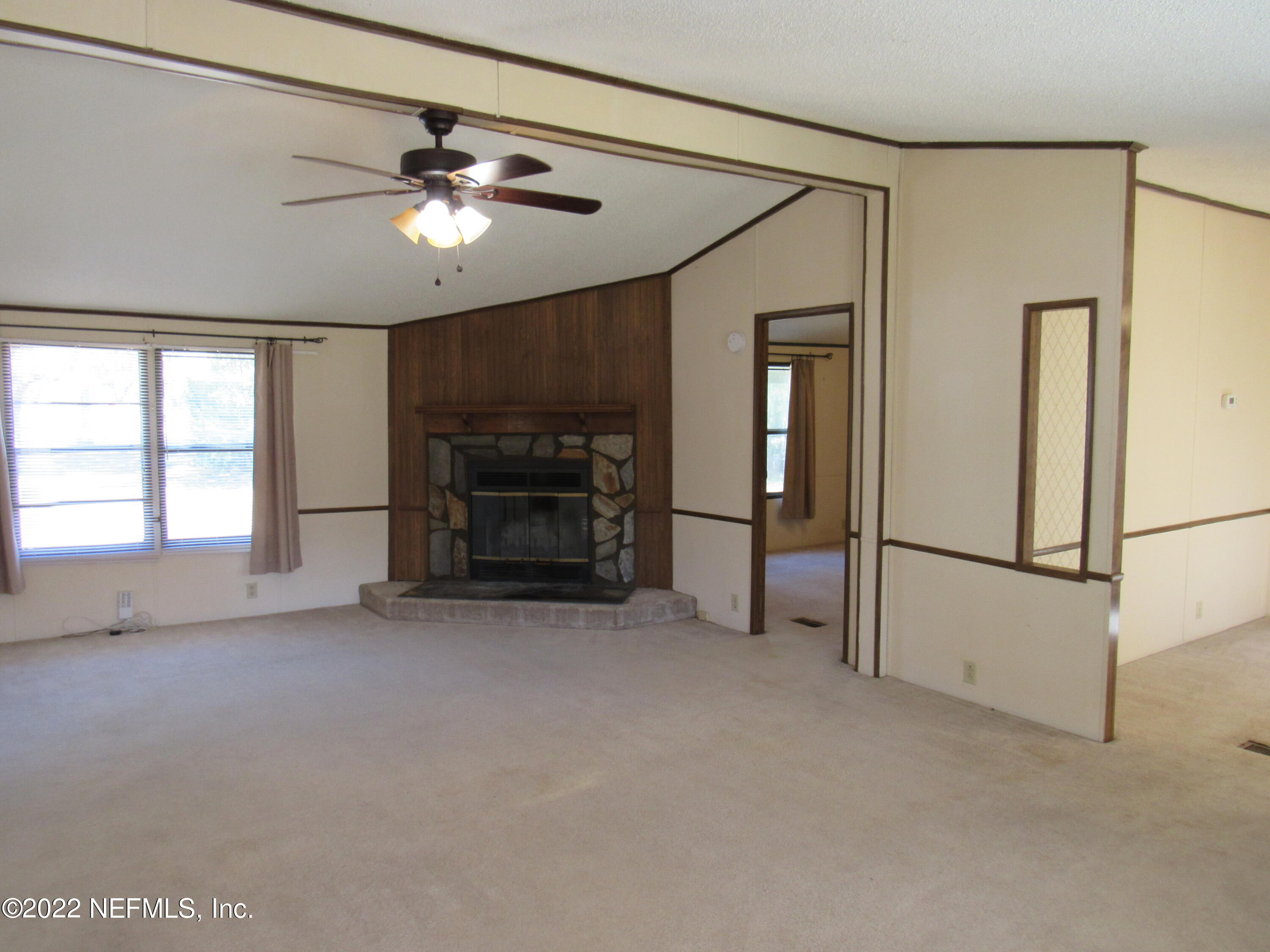 2284 Marlee Road South Jacksonville, FL 32259 - Photo 8 of 19 a view of empty room with fireplace and fan