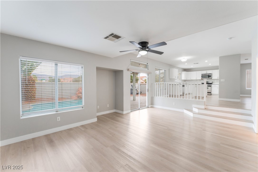 3695 Funston Way Las Vegas, NV 89129 - Photo 18 of 43 Unfurnished living room with light wood-type flooring, ceiling fan, and recessed lighting