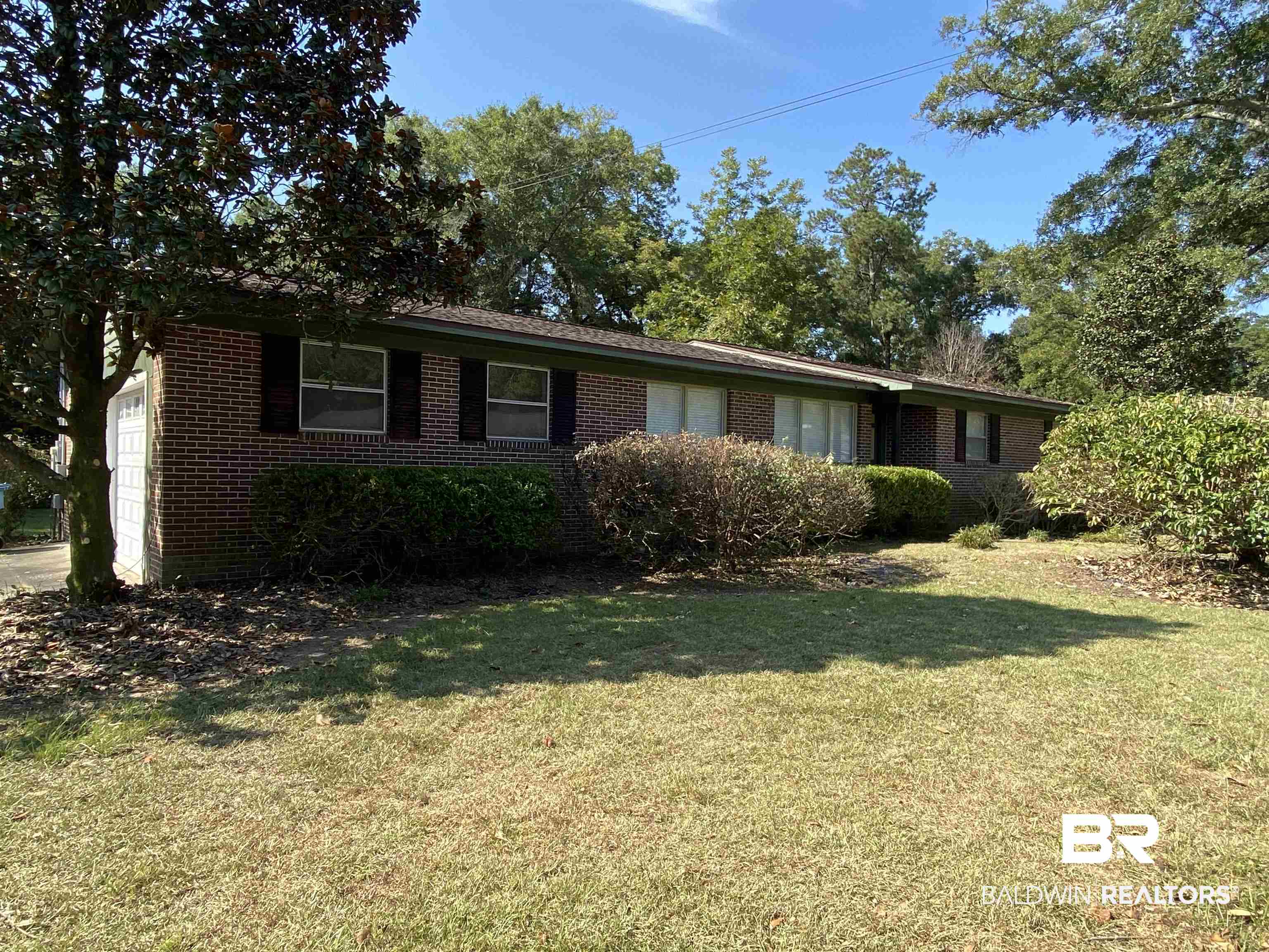 106 Terry Drive Brewton, AL 36426 - Photo 2 of 25 Ranch-style home featuring brick siding, a front yard, and a garage