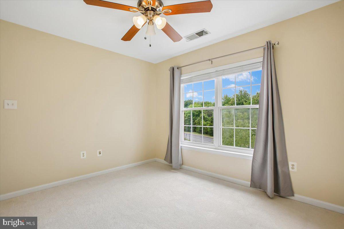 7301 Oldham Leeds Way Springfield, VA 22150 - Photo 19 of 34 an empty room with a window and a fan