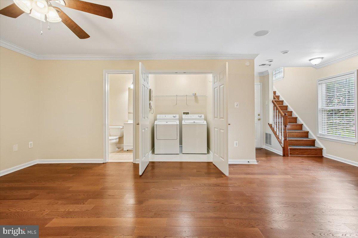 7301 Oldham Leeds Way Springfield, VA 22150 - Photo 26 of 34 a view of an empty room with wooden floor and a window