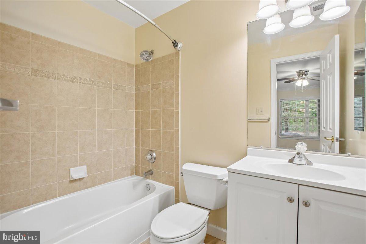 7301 Oldham Leeds Way Springfield, VA 22150 - Photo 27 of 34 a bathroom with a sink a toilet a mirror a bathtub and shower