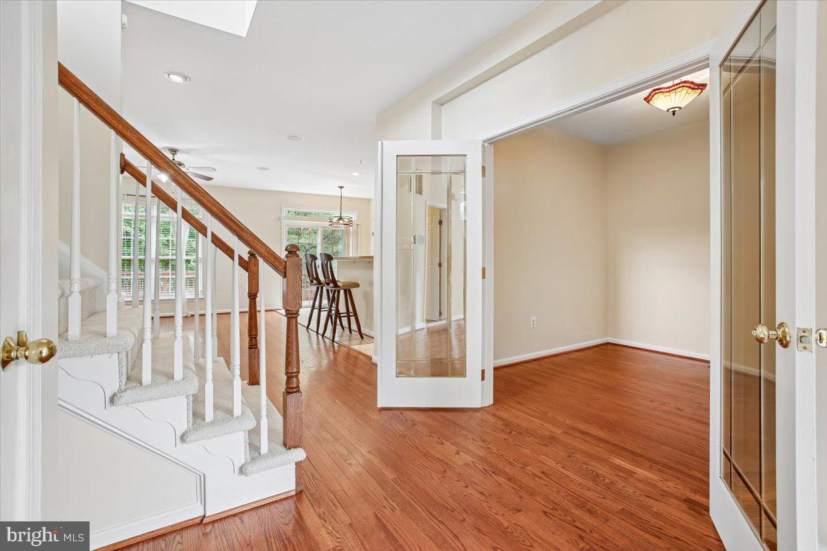 7301 Oldham Leeds Way Springfield, VA 22150 - Photo 8 of 34 a view of entryway with wooden floor and stair