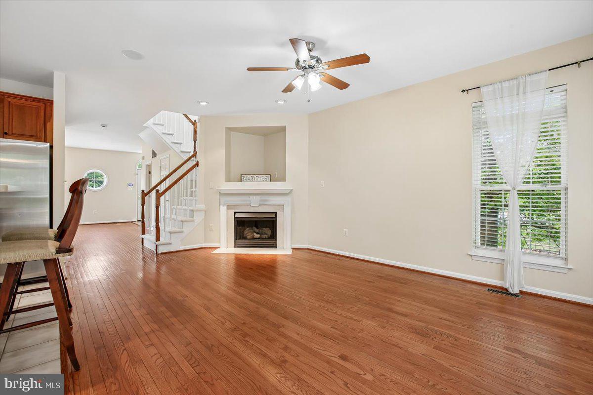 7301 Oldham Leeds Way Springfield, VA 22150 - Photo 10 of 34 a view of an empty room with wooden floor and a window