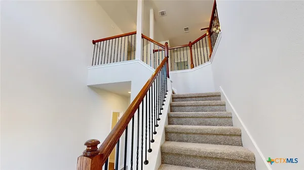 a view of entryway with stairs and wooden floor