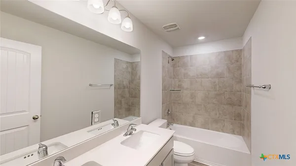 a bathroom with a sink a mirror and a shower