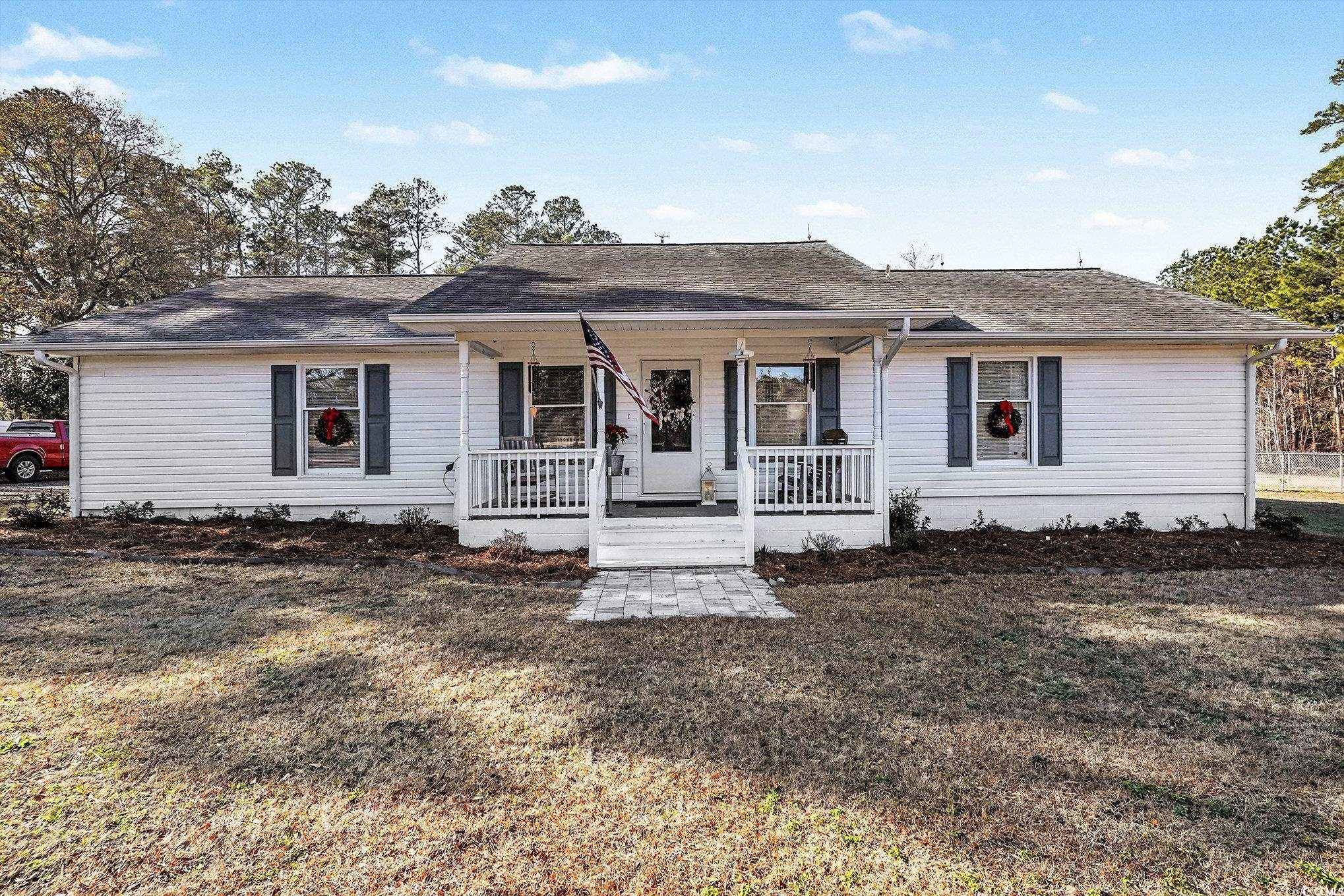 5175 Bottle Branch Road Conway, SC 29527 - Photo 1 of 28 Ranch-style home featuring covered porch, a shingled roof, and a front lawn