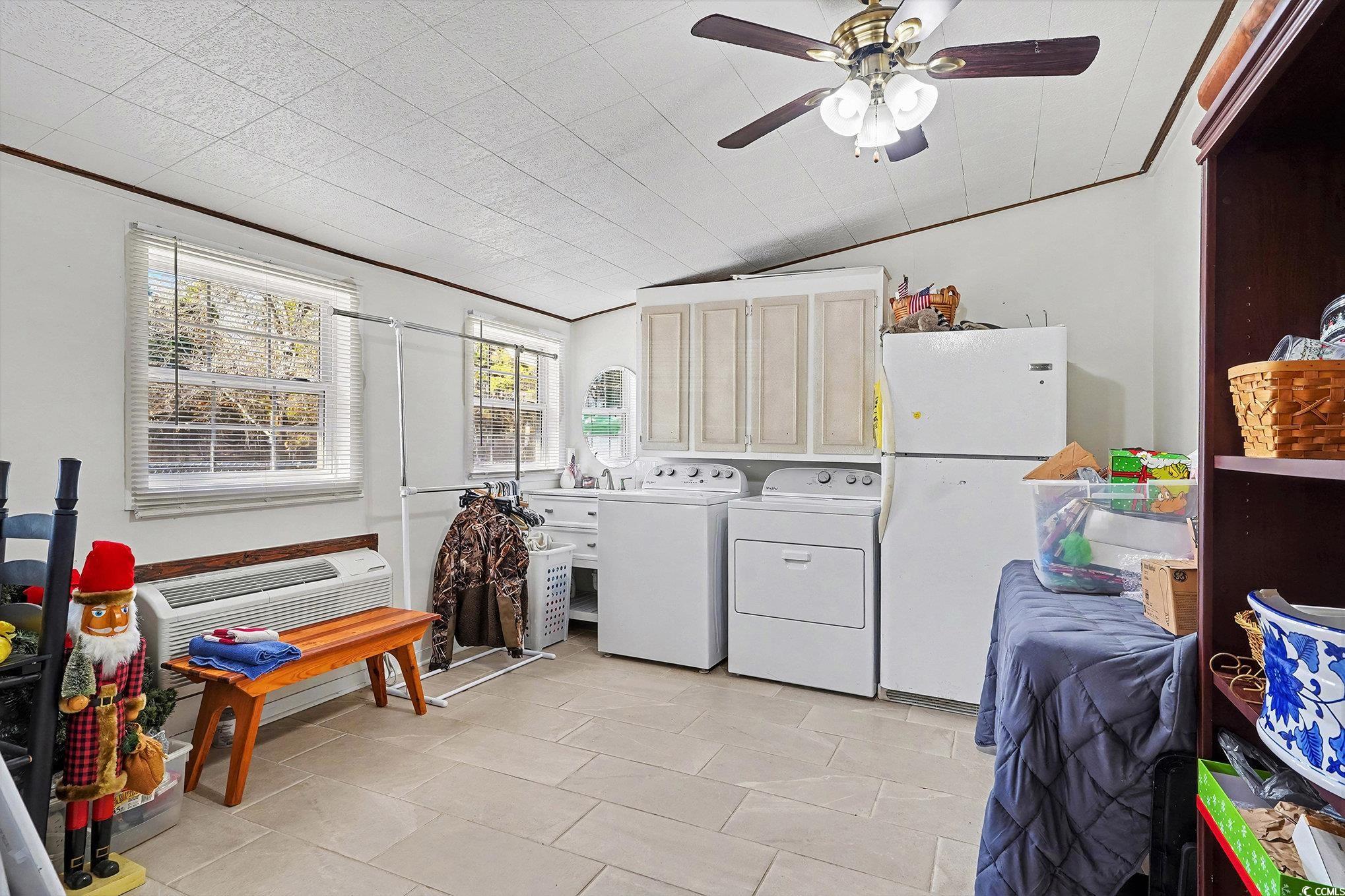5175 Bottle Branch Road Conway, SC 29527 - Photo 11 of 28 Kitchen with white appliances, light countertops, decorative backsplash, brown cabinets, and a peninsula