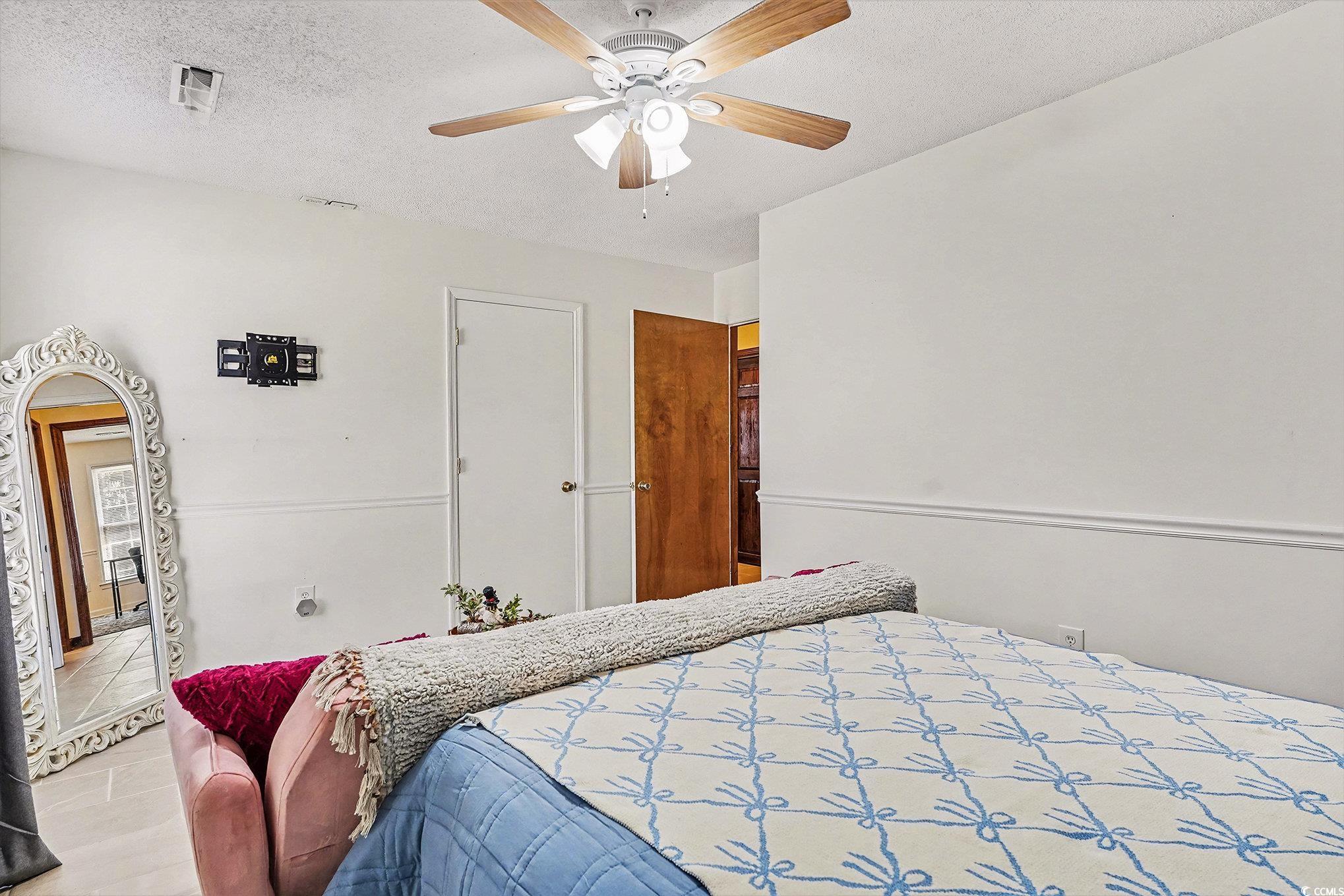 5175 Bottle Branch Road Conway, SC 29527 - Photo 16 of 28 Bedroom featuring a textured ceiling, a desk, a ceiling fan, and light tile patterned floors