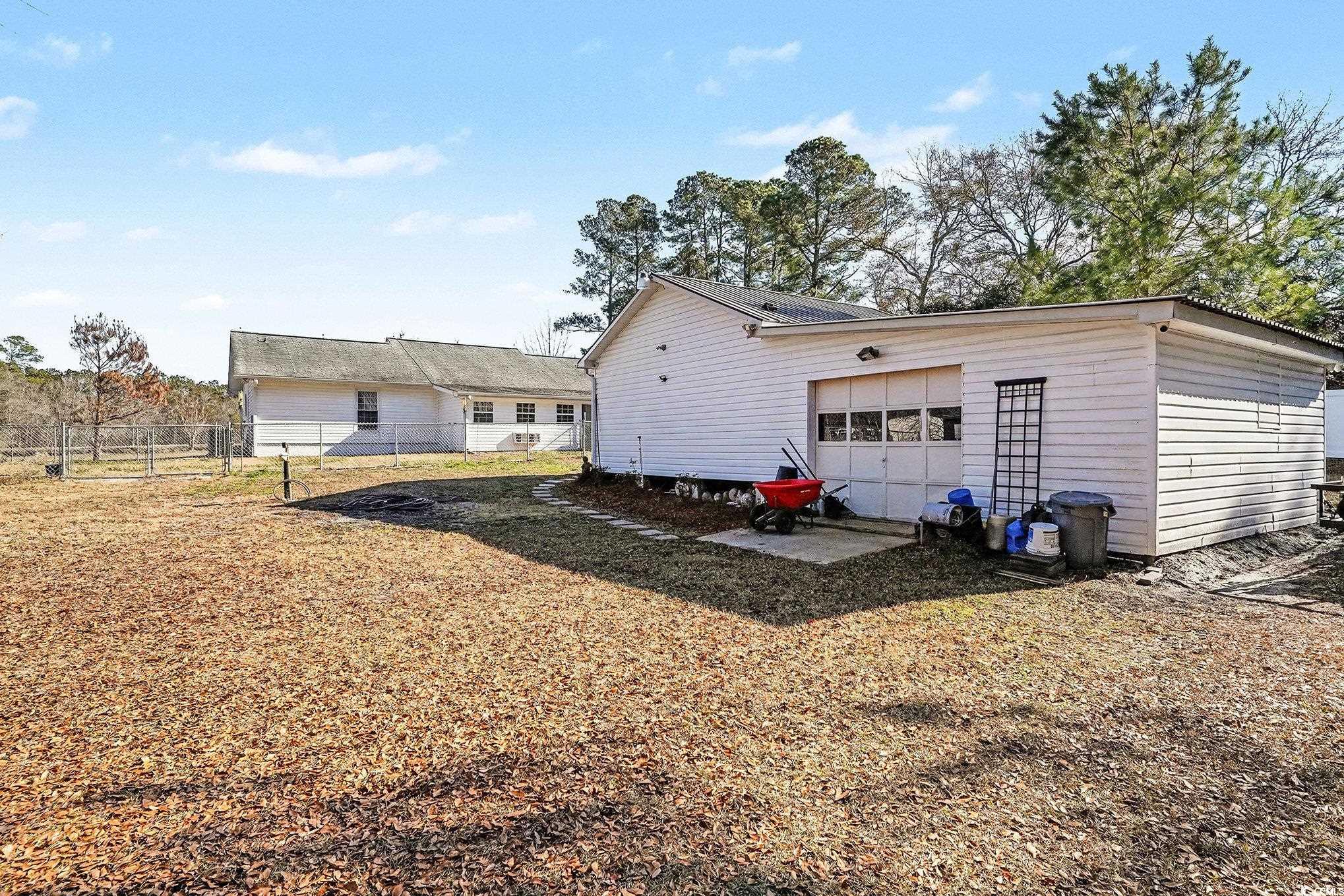 5175 Bottle Branch Road Conway, SC 29527 - Photo 27 of 28 Back of property with a patio area, a gate, a shingled roof, and an outdoor fire pit
