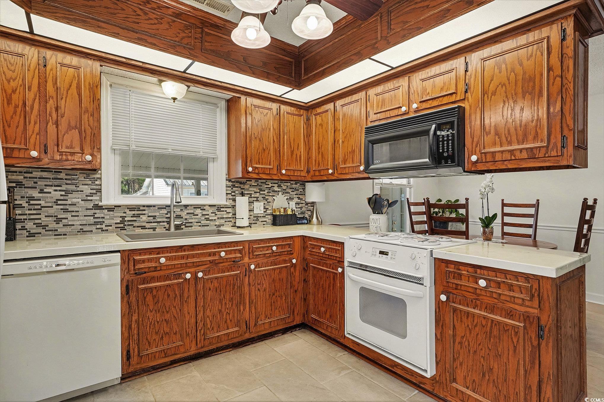 5175 Bottle Branch Road Conway, SC 29527 - Photo 9 of 28 Living room featuring a warm lit fireplace, a ceiling fan, tile patterned flooring, and high vaulted ceiling