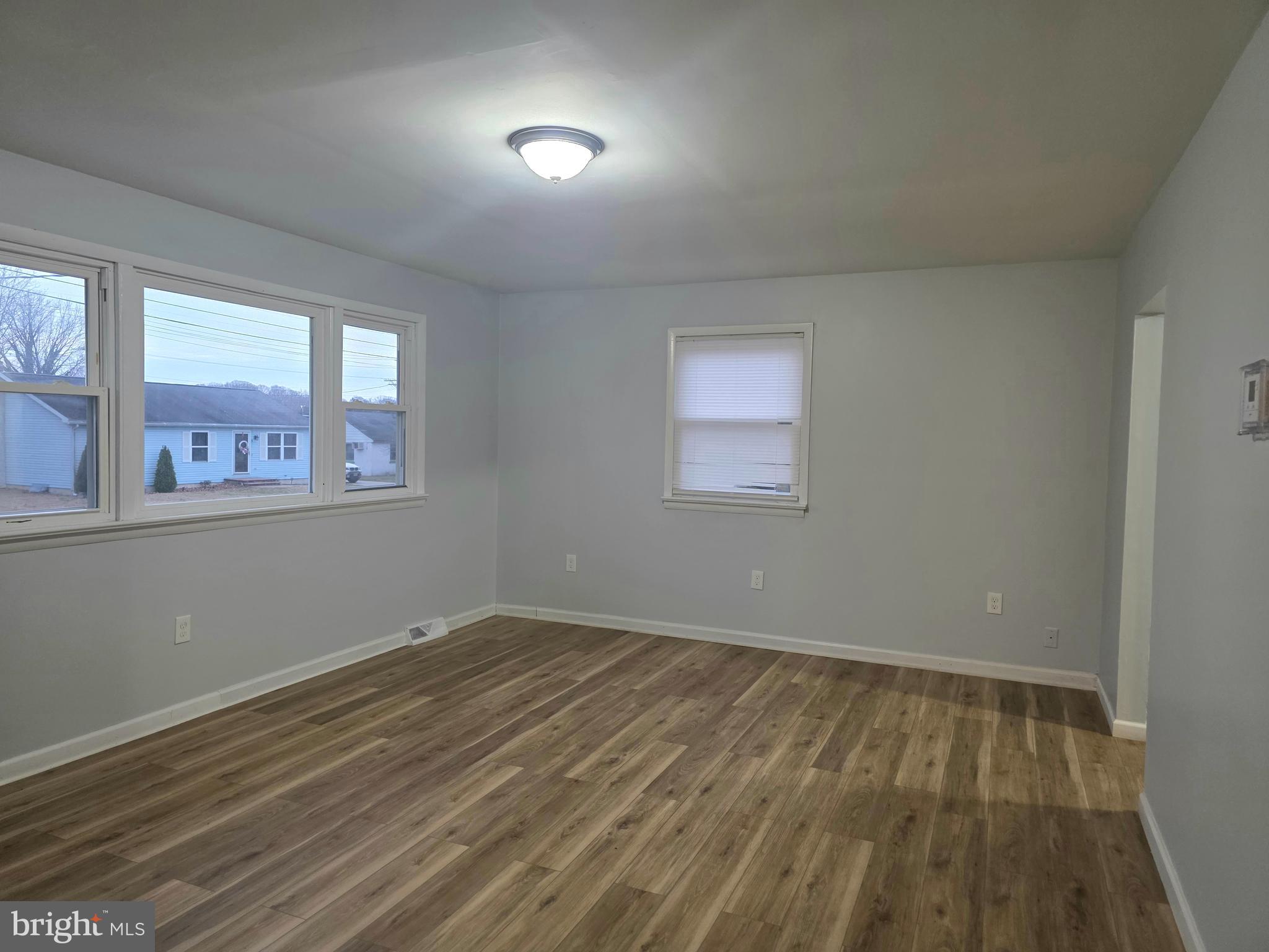11 Fairview Avenue Bridgeton, NJ 08302 - Photo 13 of 33 an empty room with wooden floor and windows