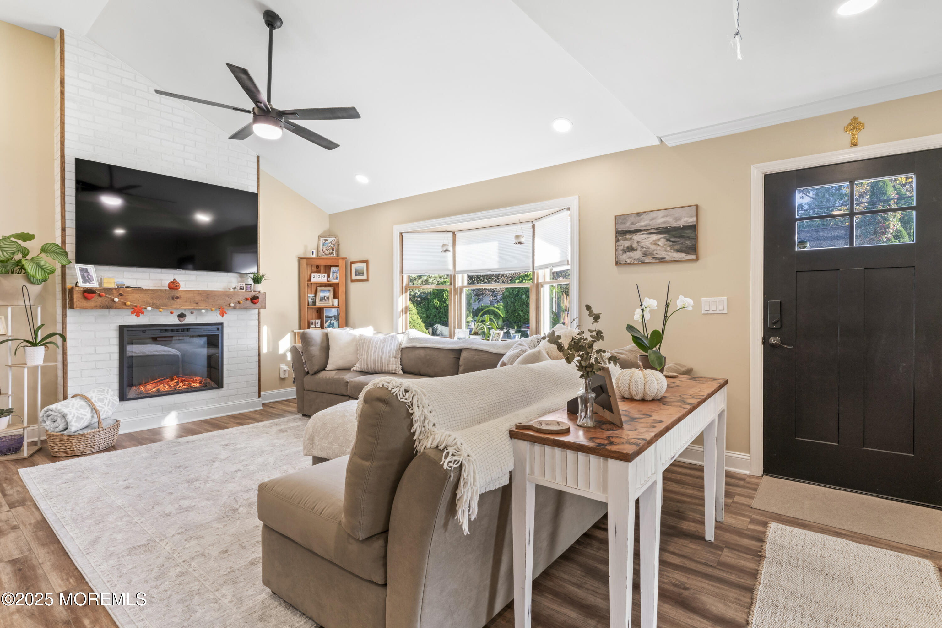 240 Timberline Road Toms River, NJ 08753 - Photo 11 of 25 a living room with furniture a flat screen tv and a fireplace
