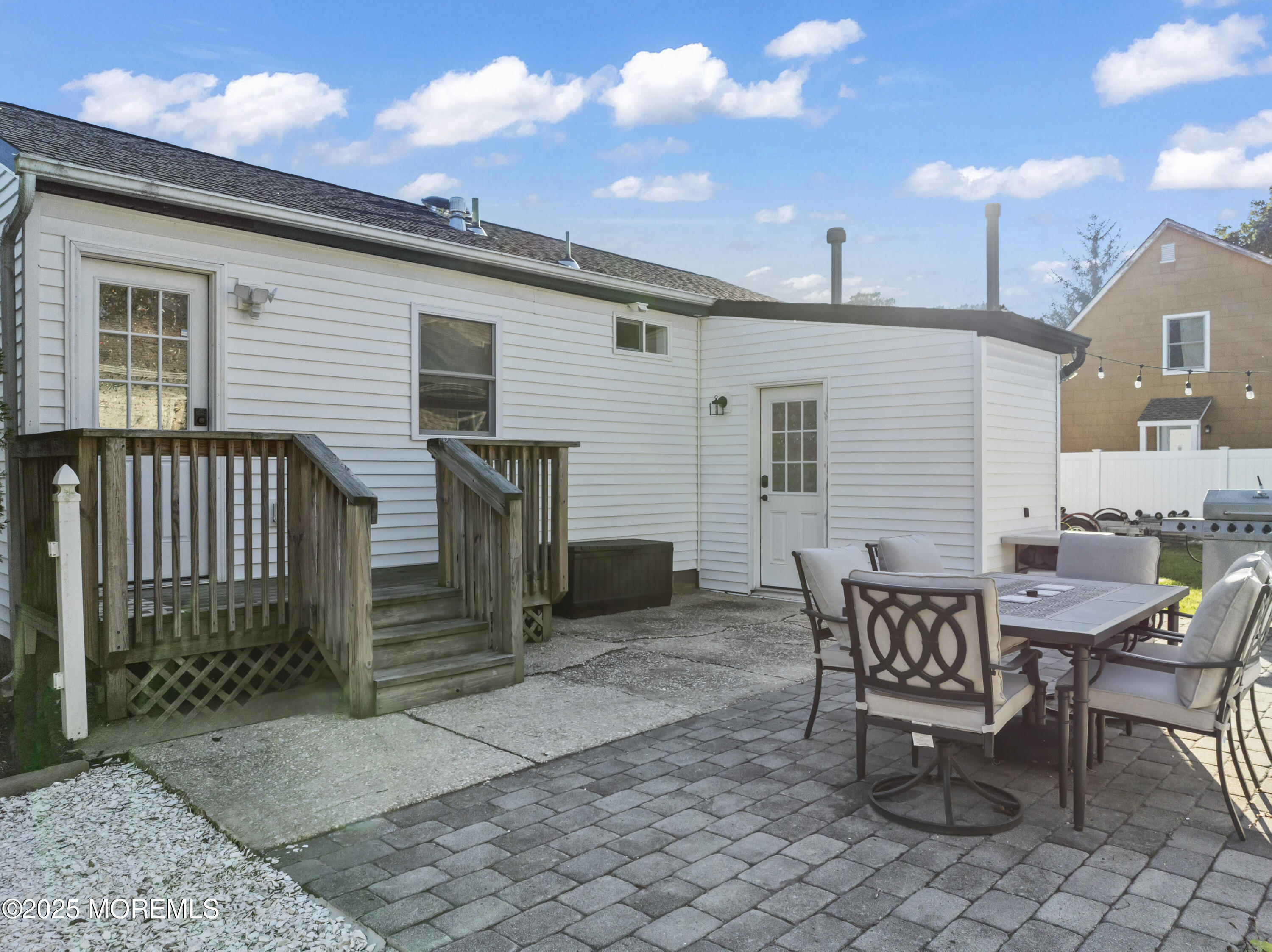 240 Timberline Road Toms River, NJ 08753 - Photo 5 of 25 a view of a patio with a table and chairs and wooden fence