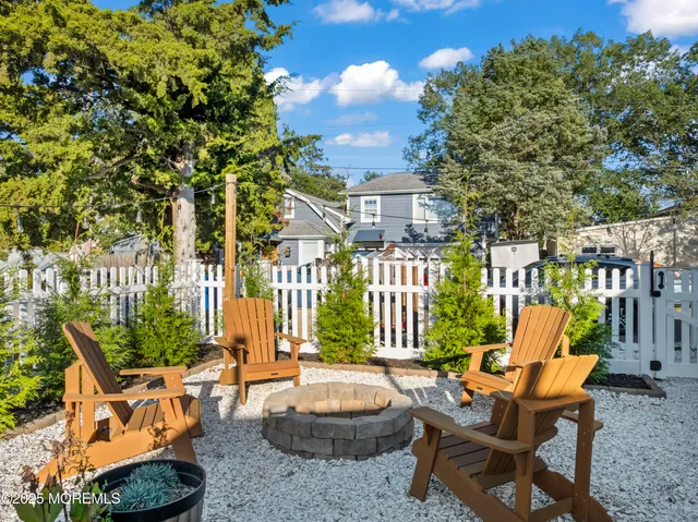 a view of a patio with couches table and chairs and potted plants