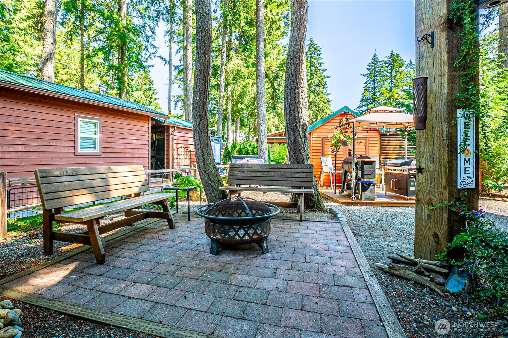 1546 Reservation Road Southeast, Unit 253 Olympia, WA 98513 - Photo 18 of 38 a view of a patio with table and chairs potted plants and a large tree