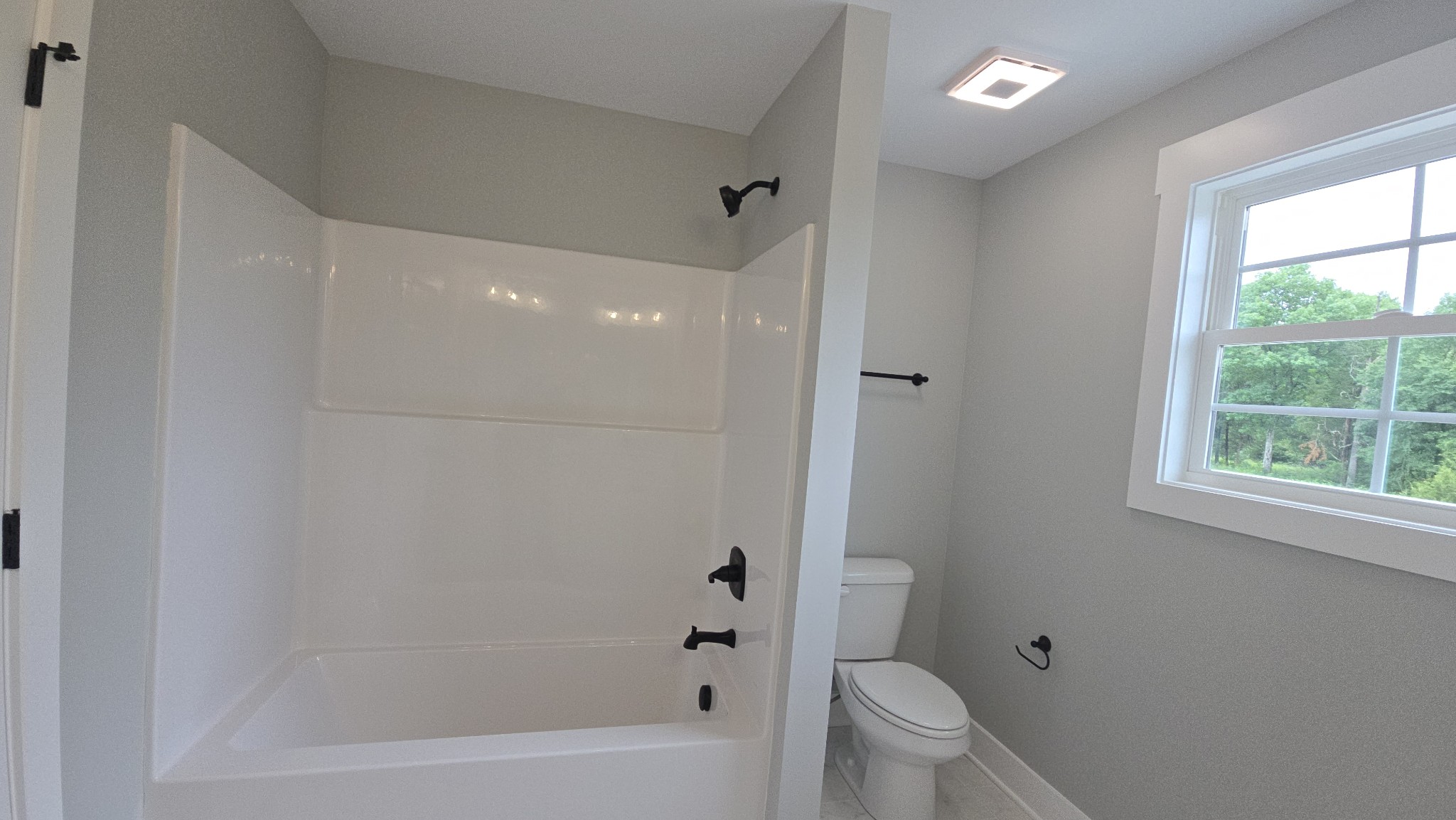 11533 Karo Road Bell Buckle, TN 37020 - Photo 18 of 22 a bathroom with a bathtub toilet and window