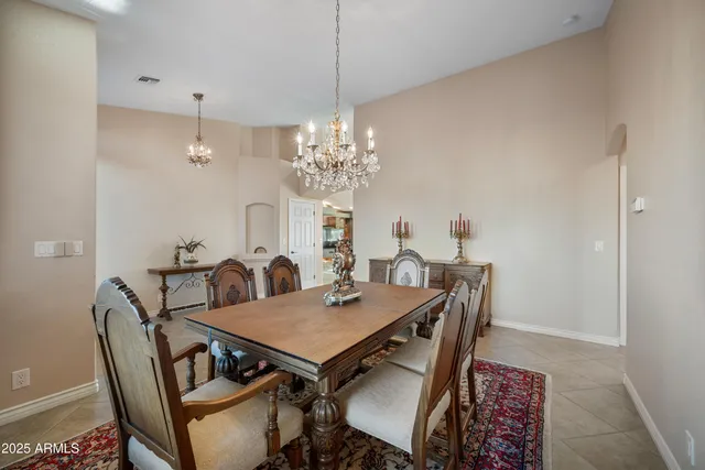 a view of a dining room with furniture and chandelier