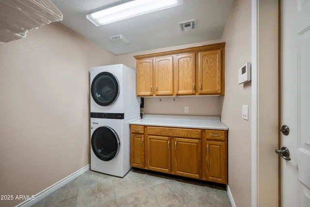 a utility room with sink dryer and washer