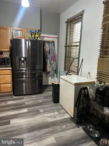 a kitchen with a refrigerator and a stove