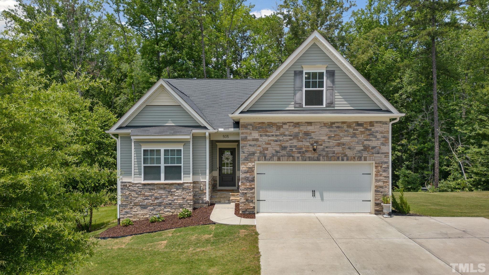 505 Miners Loop Sanford, NC 27330 - Photo 1 of 45 a front view of a house with a yard and garage