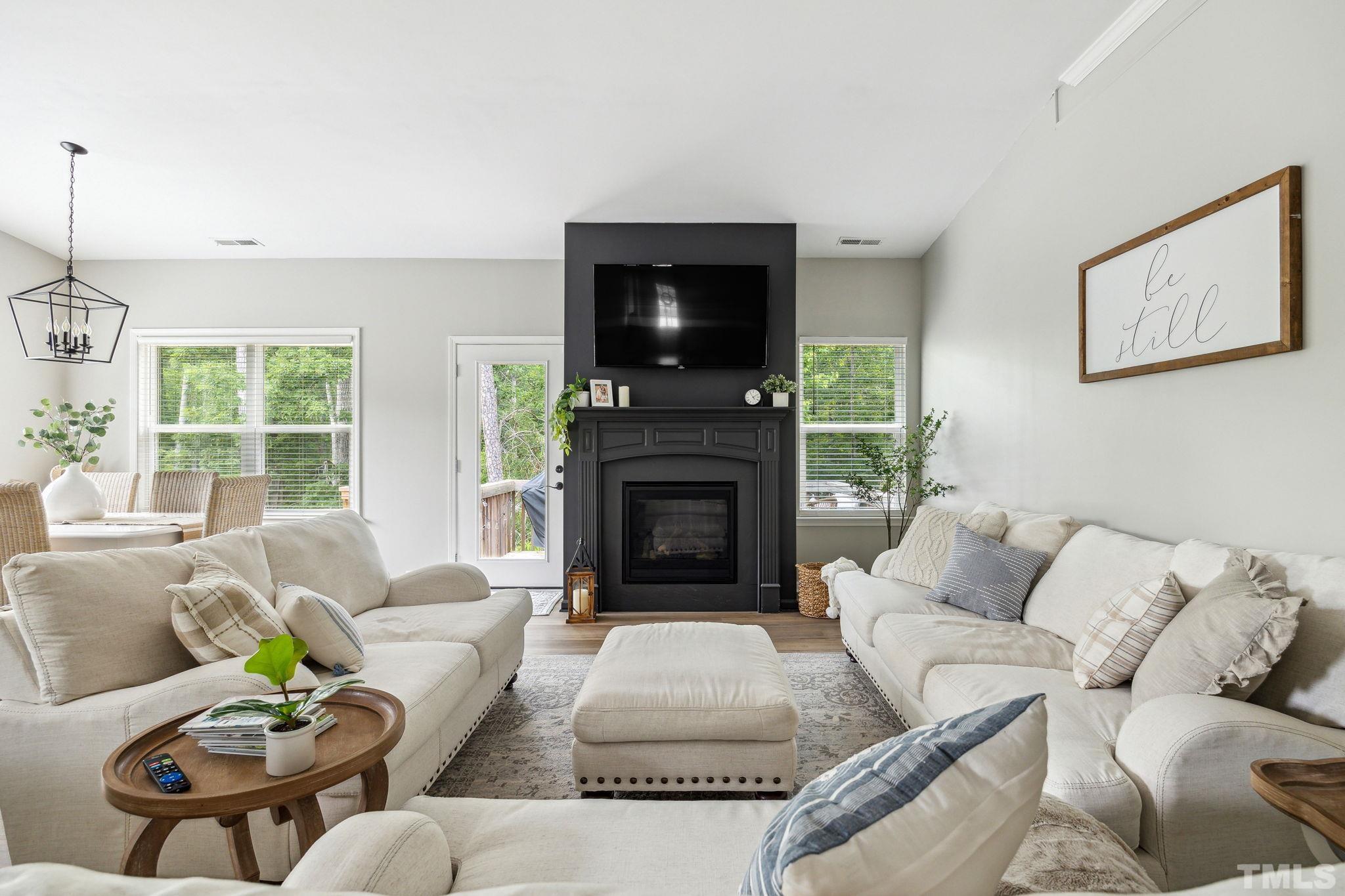 505 Miners Loop Sanford, NC 27330 - Photo 11 of 45 a living room with furniture a flat screen tv and a fireplace